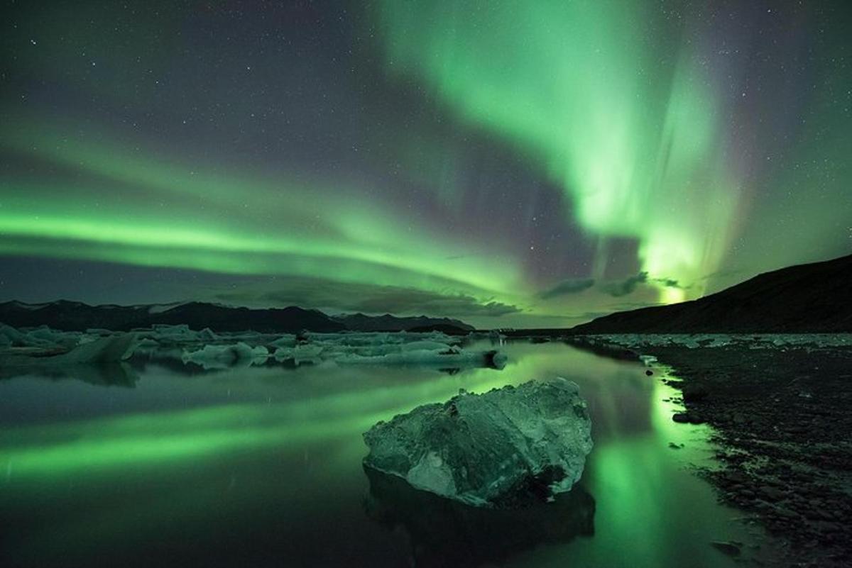 an aurora in the sky over a body of water