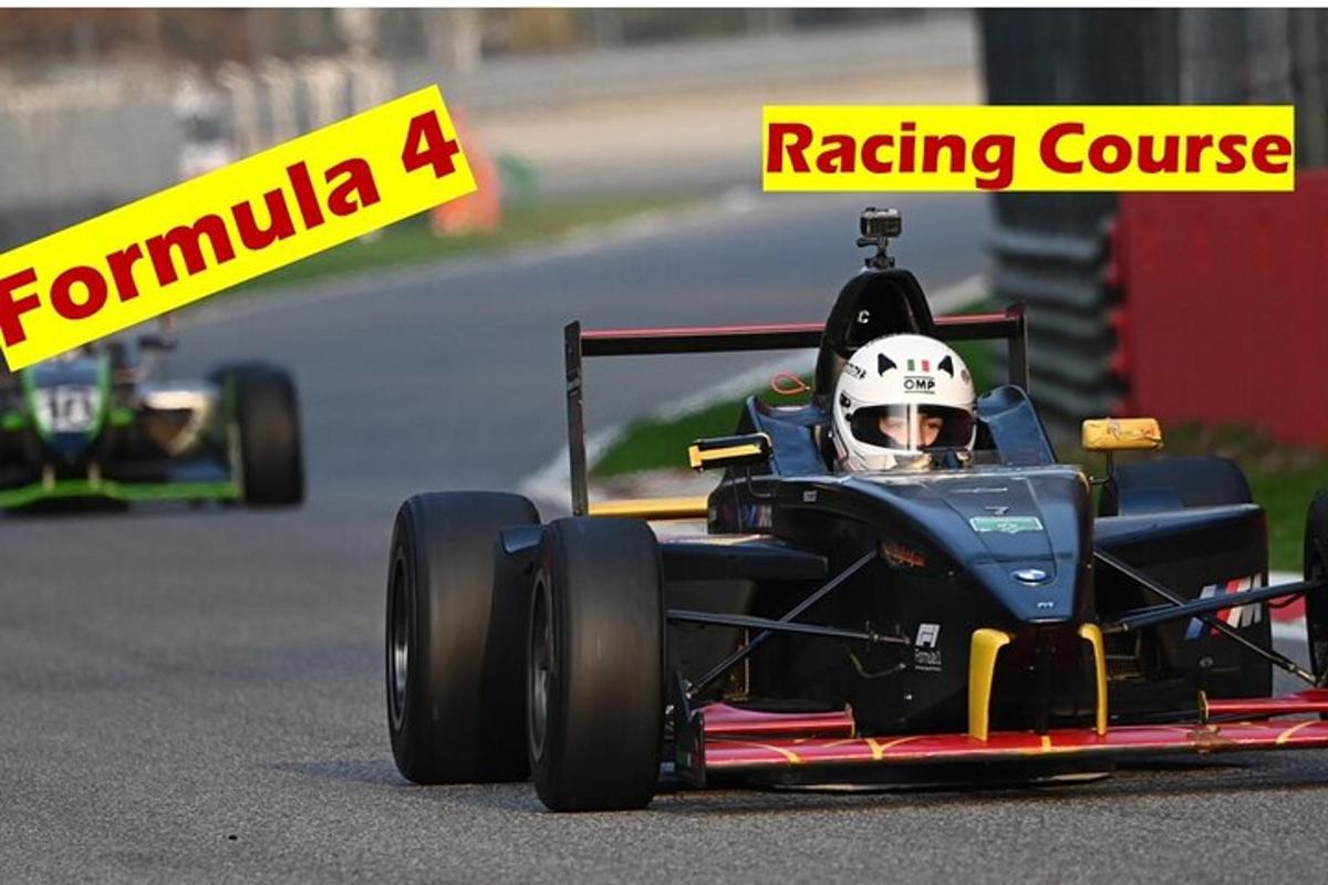 a man driving a race car on a track