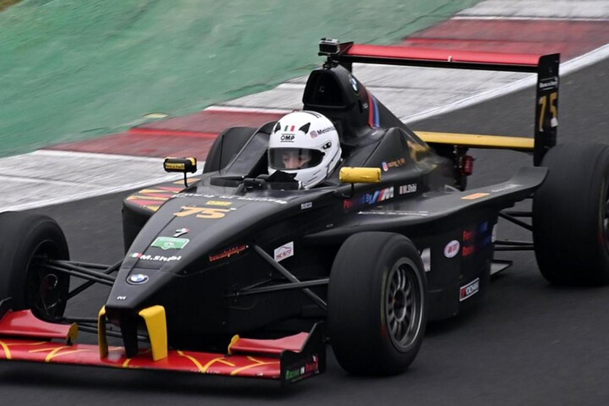 a person in a race car on a track