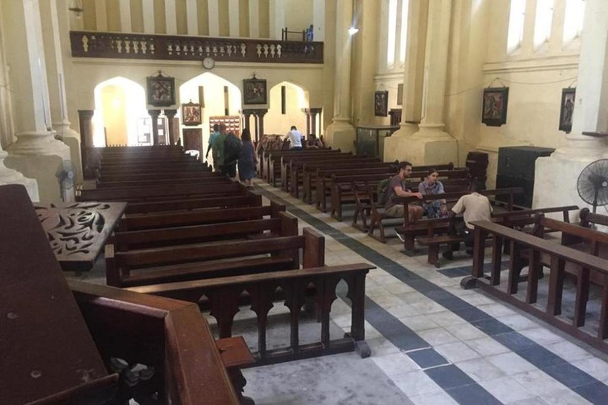 a church with wooden pews and people sitting in it