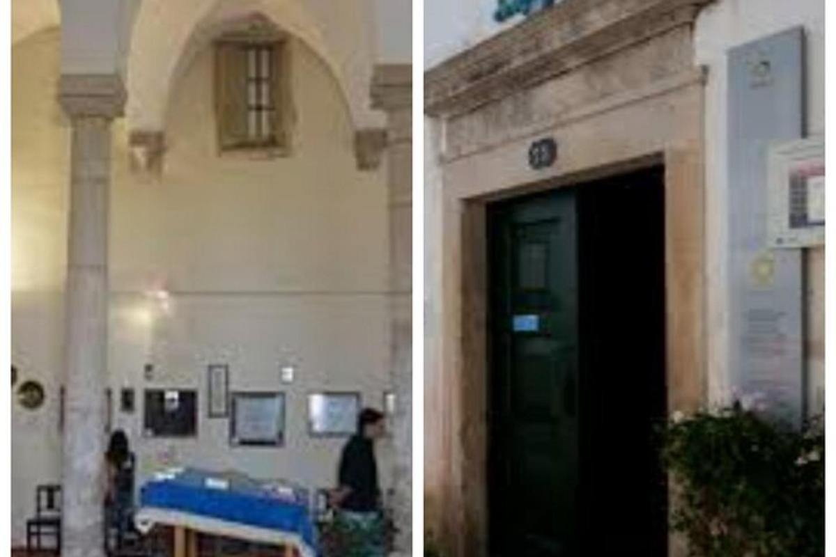 a building with a door and a person standing in front of it