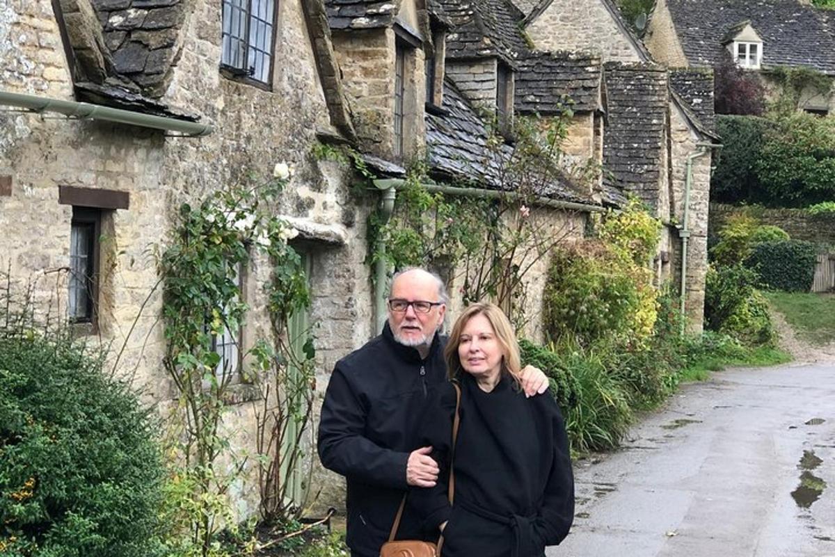 a man and a woman standing in front of a building
