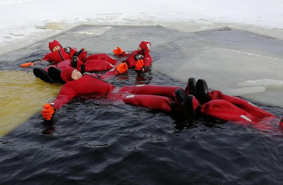 a group of people in red suits in the water