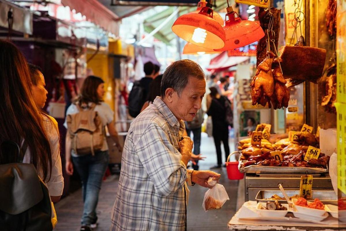a man standing in a market looking at food
