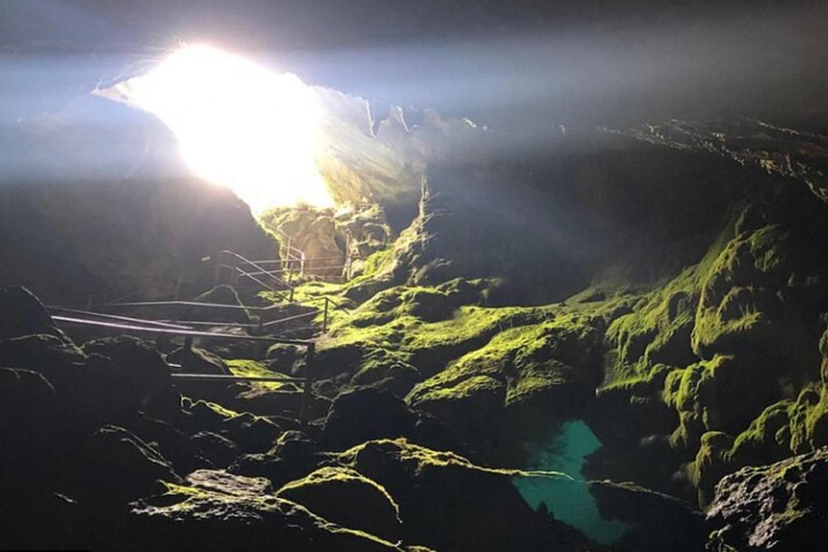 a view from the top of a cave with the sun shining