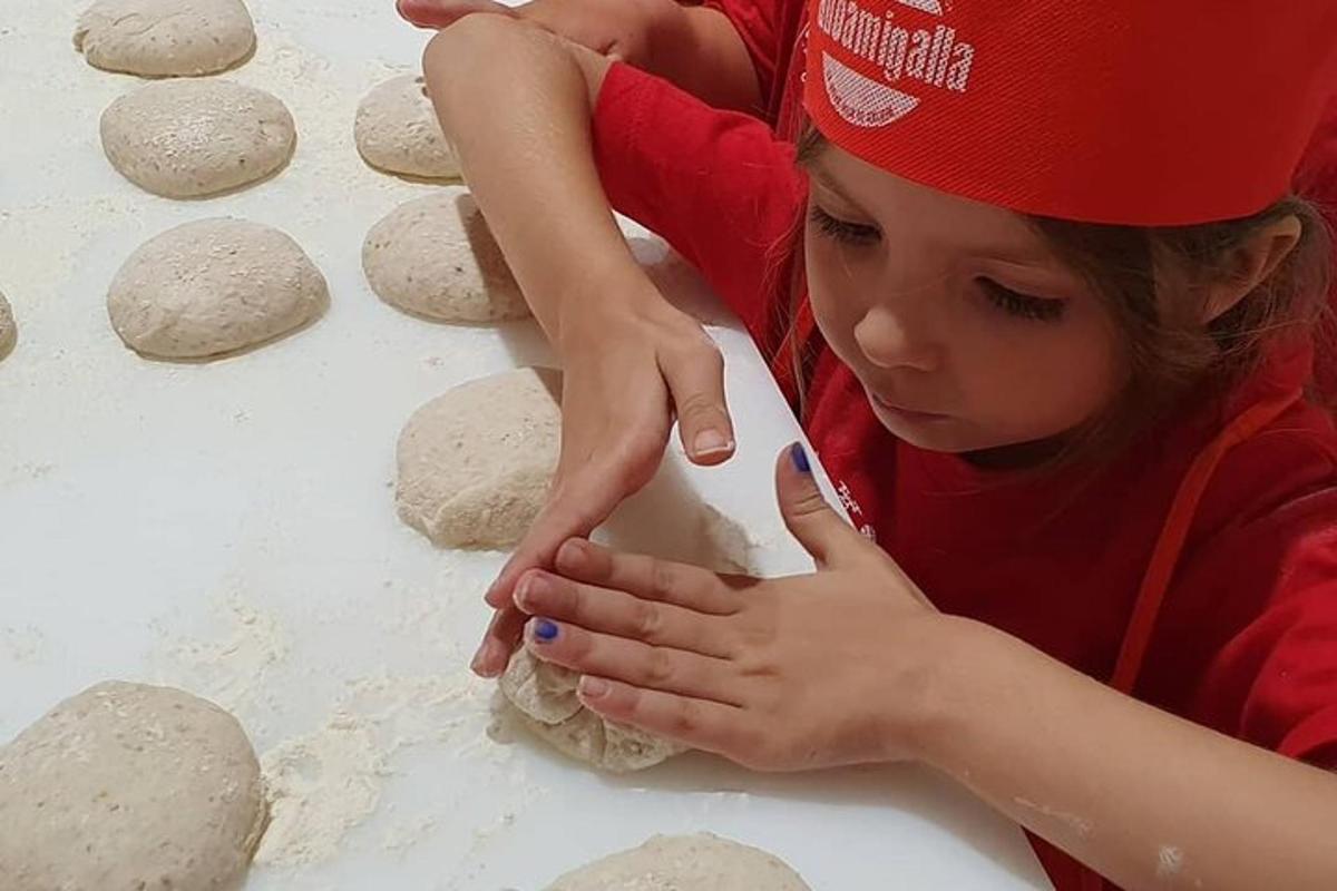 a young girl making dough on a table