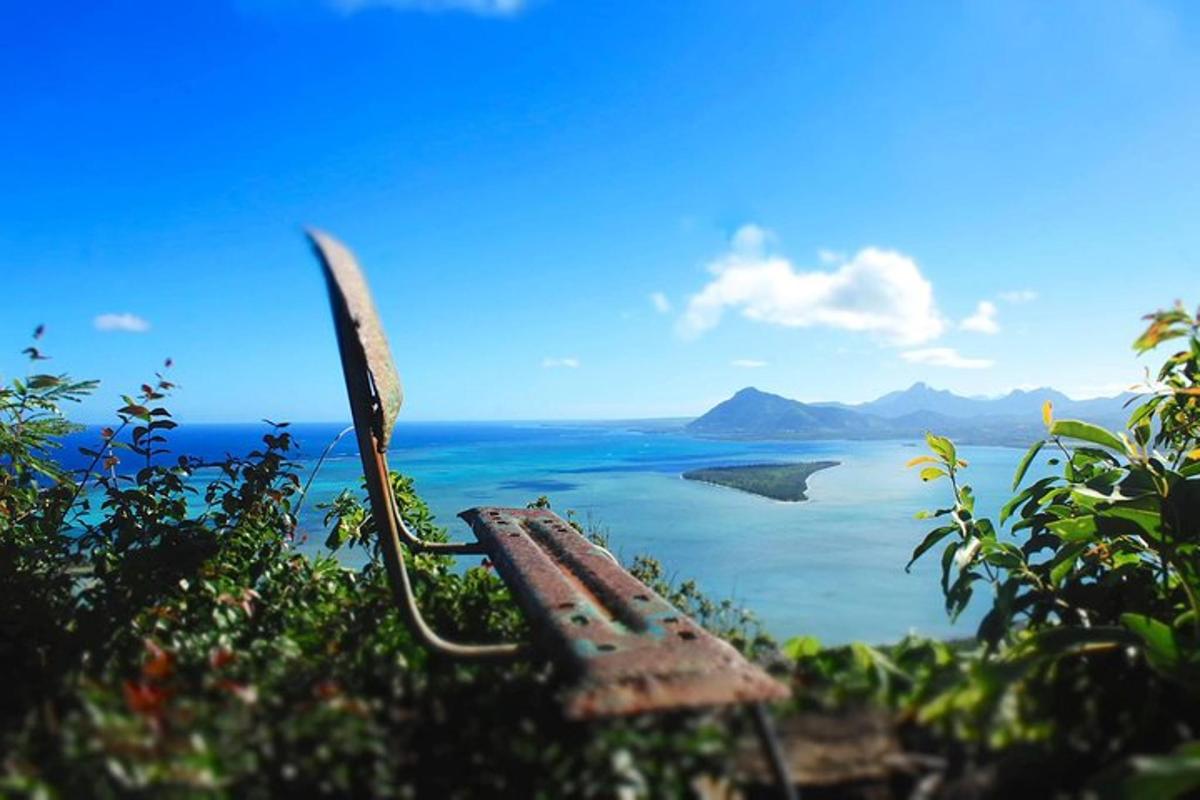 an old bench sitting on top of a hill overlooking a body of water