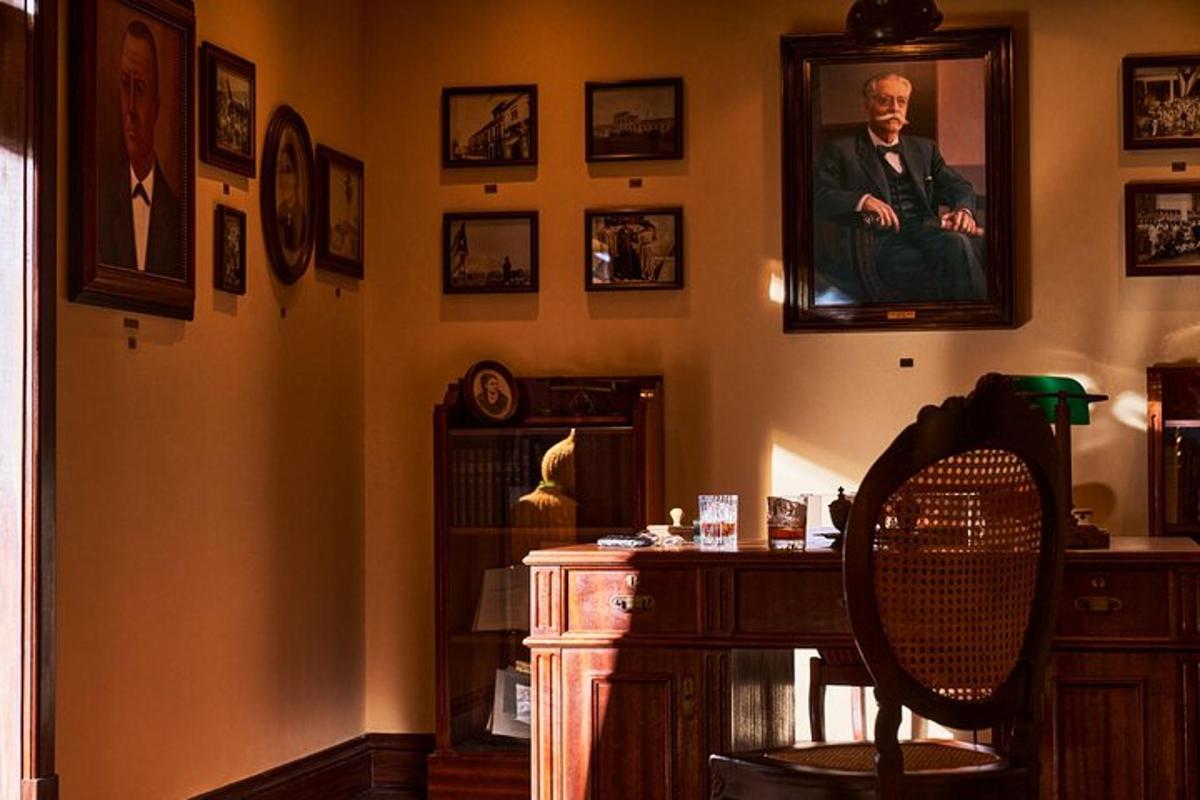 a living room with a portrait of a man on the wall