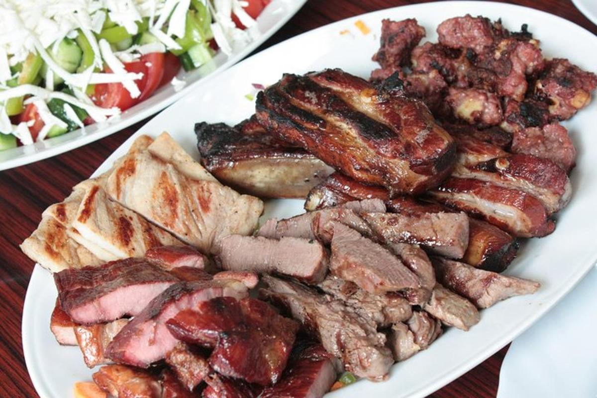 a plate of food with meat and a salad