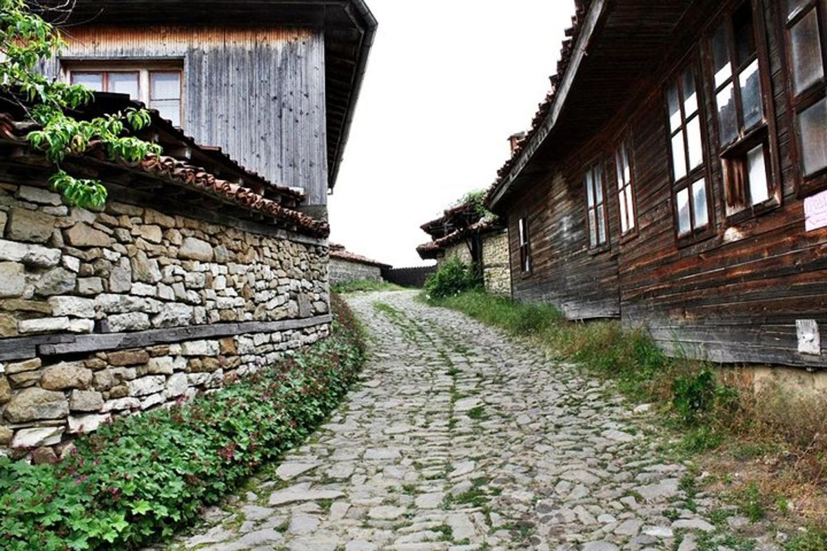 an old stone road next to a building