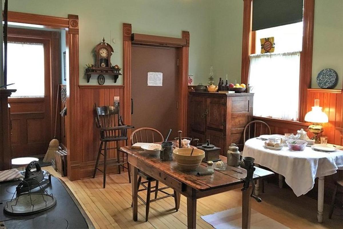 a living room with a table and a kitchen