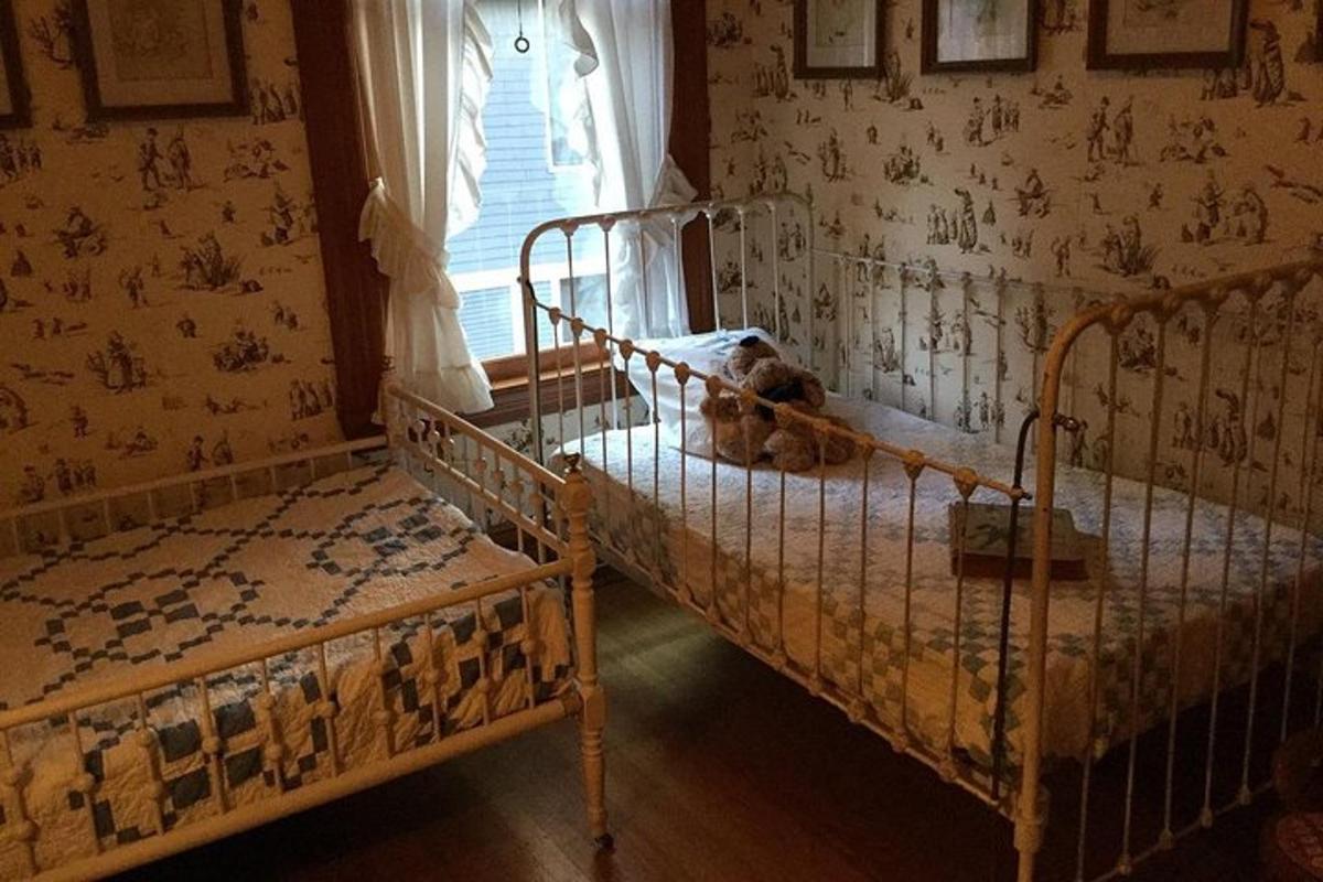 a bedroom with two bunk beds with a teddy bear sitting on them