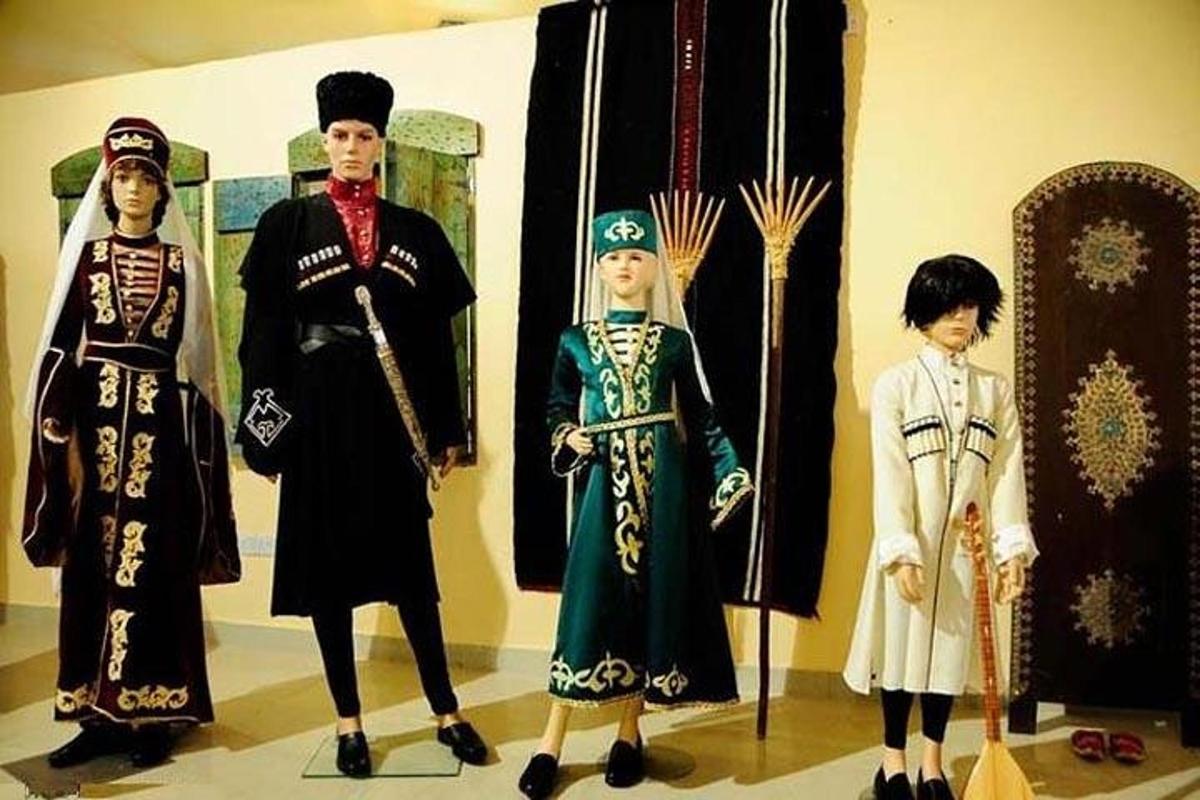 three figurines of people in uniforms on display in a museum