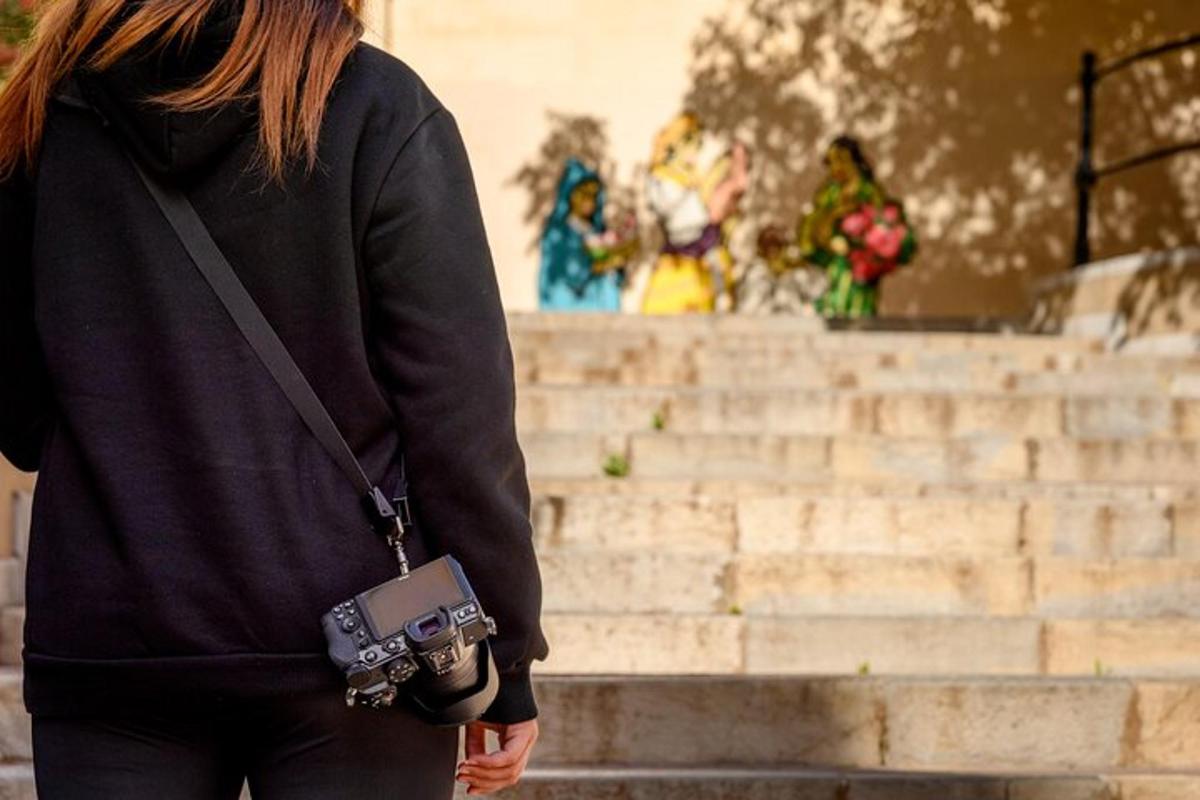 a woman is holding a camera in front of some stairs