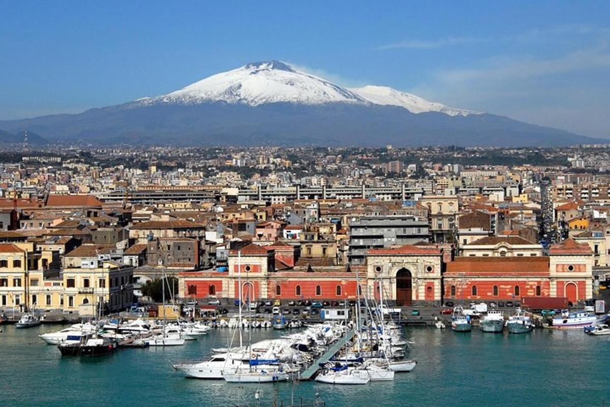 a city with a marina with a mountain in the background