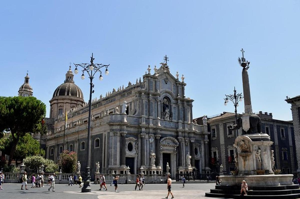 Un gran edificio con una estatua delante.
