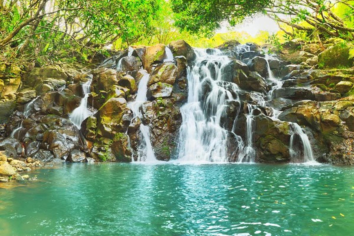 a waterfall in the middle of a pool of water