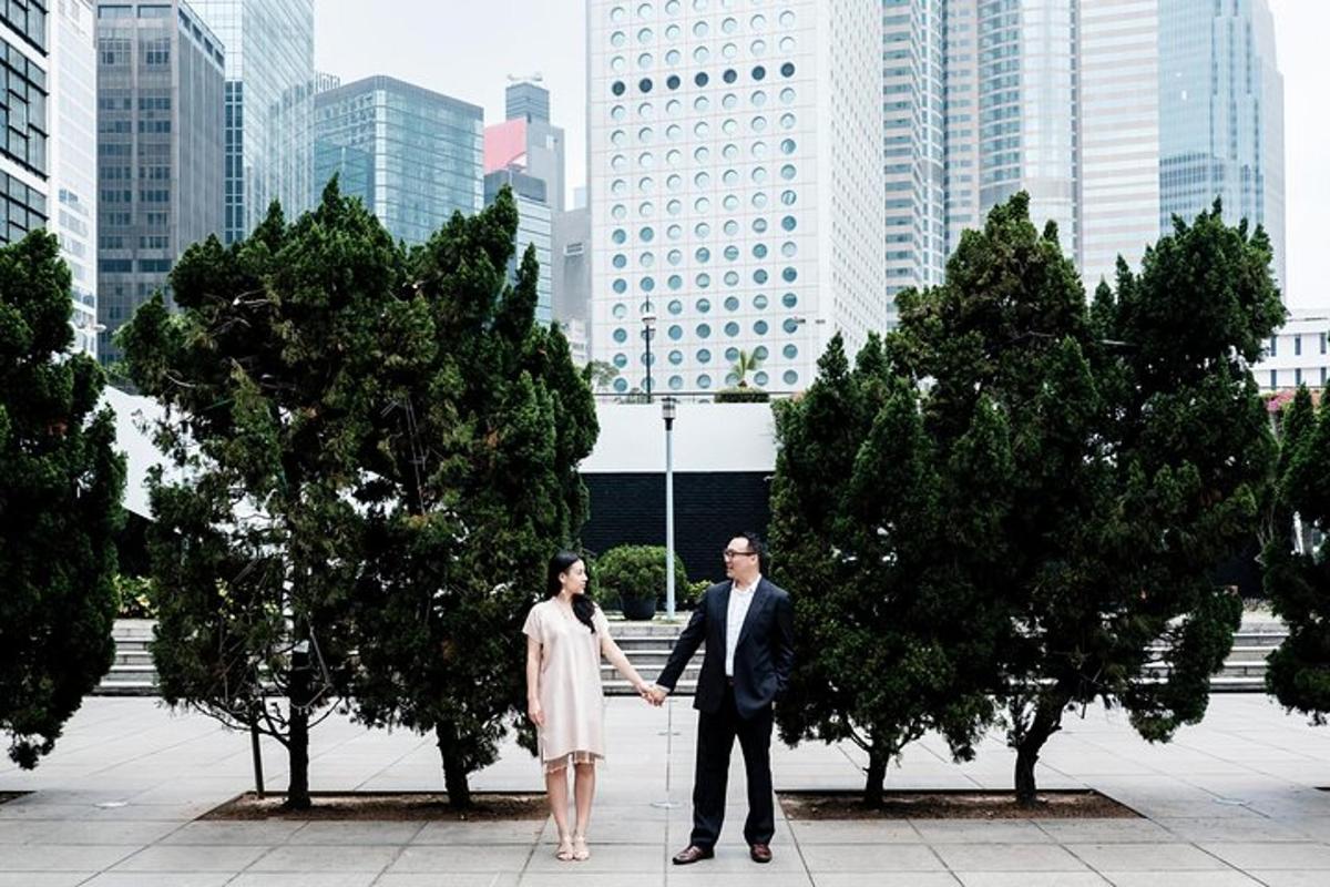 a man and a woman holding hands in a city