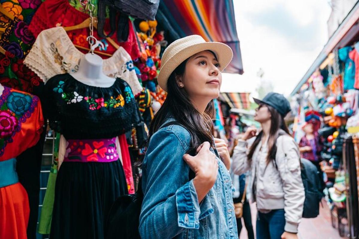 a woman standing in a market looking at a display of clothes