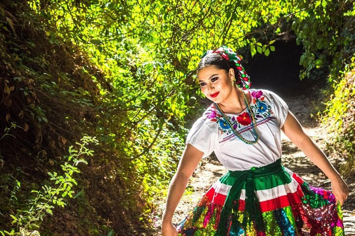 a woman in a colorful dress walking down a path