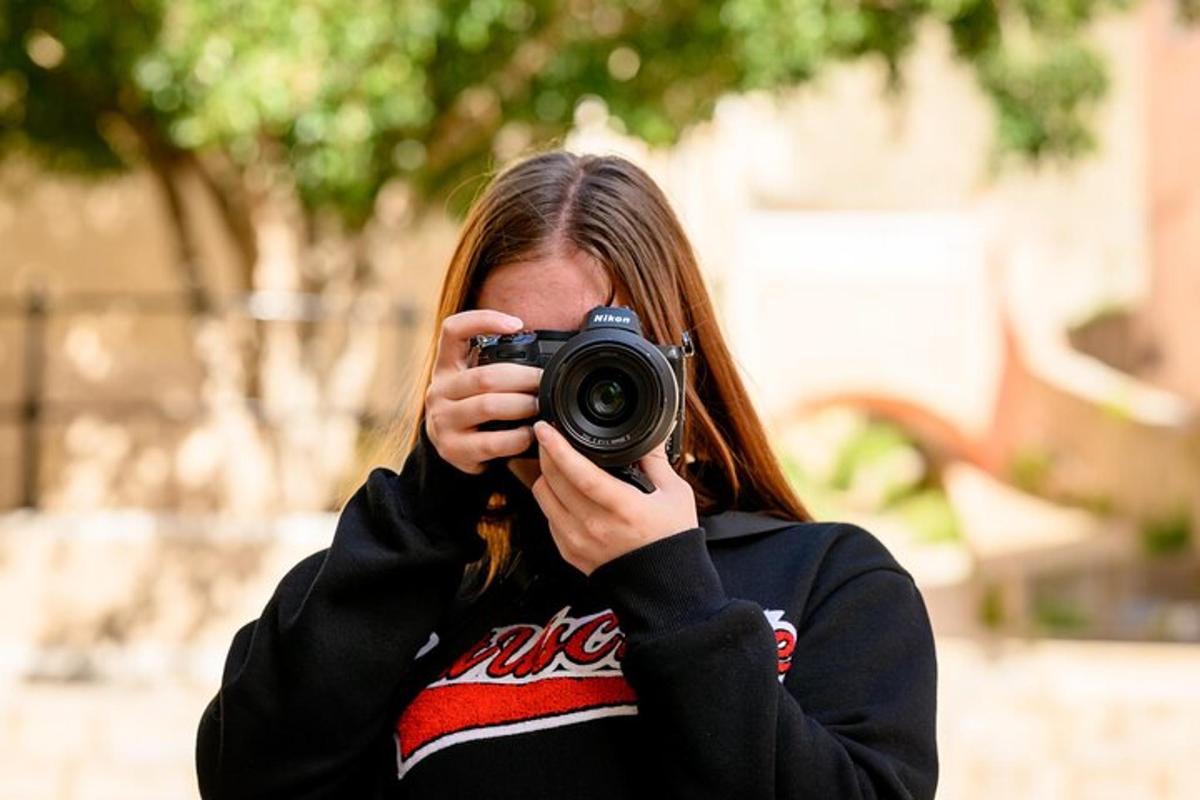 a woman taking a picture of herself with a camera