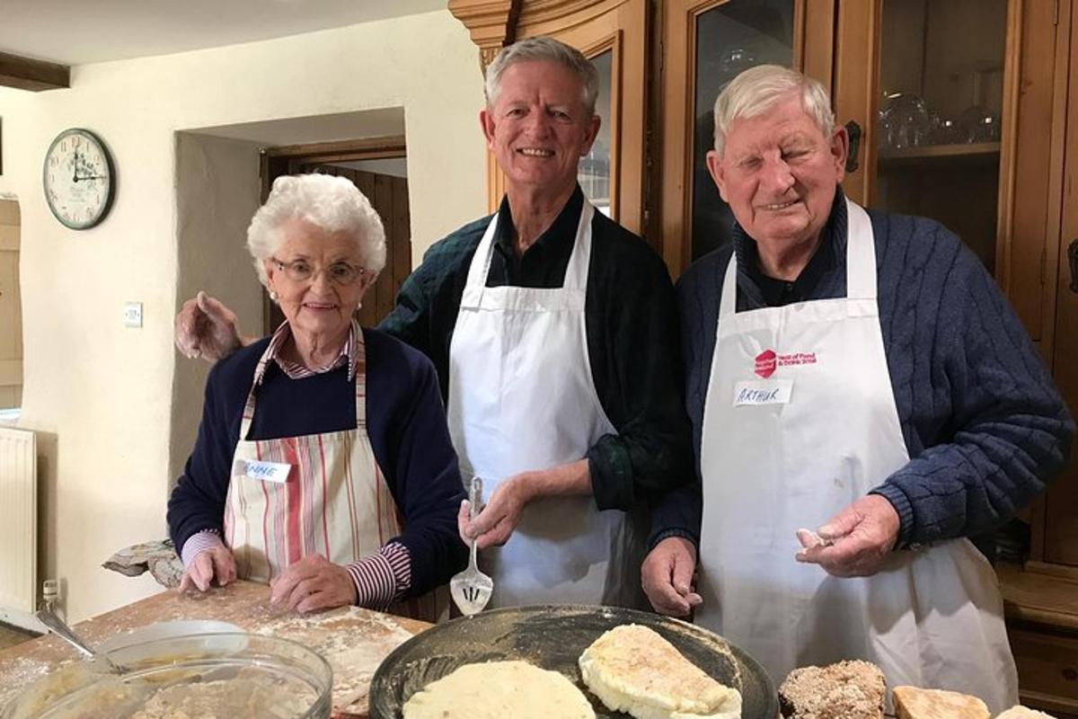 a group of three people standing in a kitchen