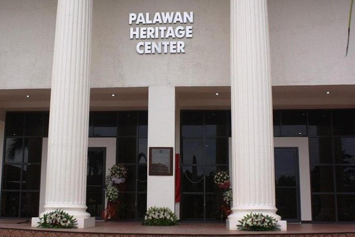 a building with columns and a sign that reads palawan heritage center
