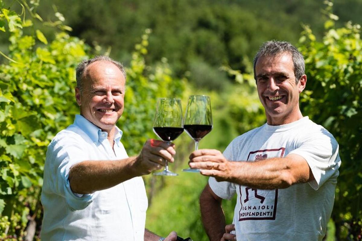 dos homes sostenint copes de vi negre