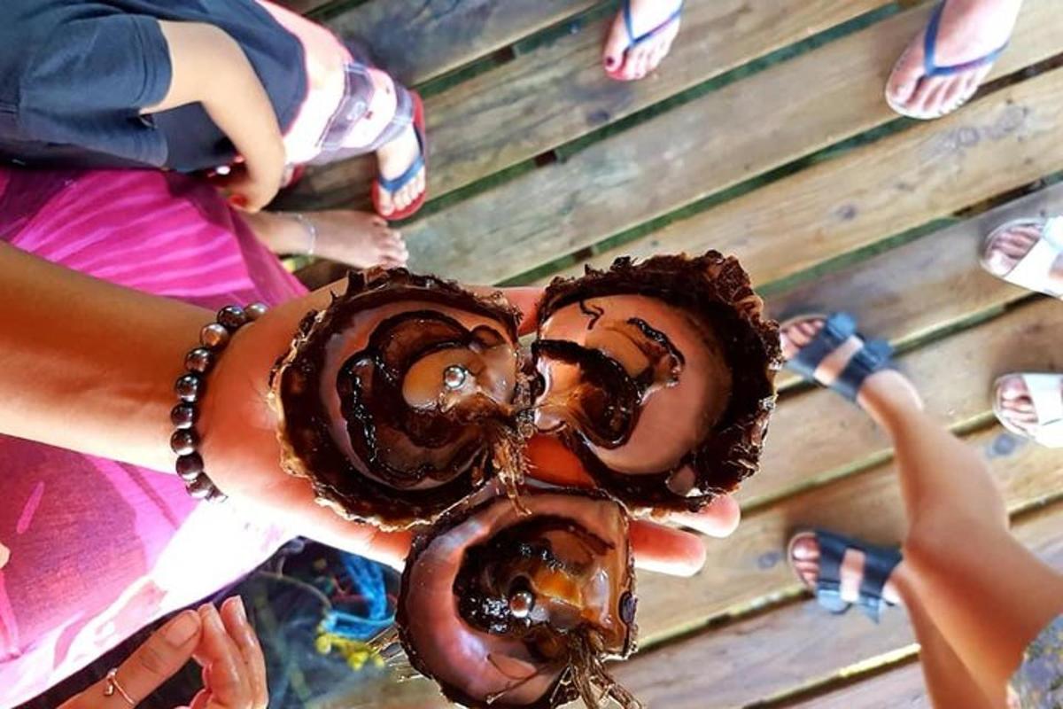 a group of people holding up chocolate covered donuts