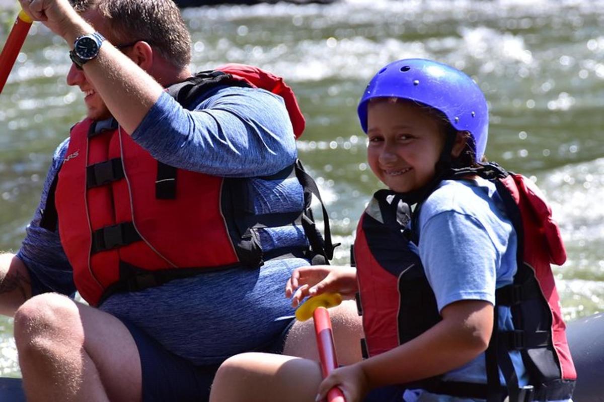 a man and a young girl on a raft on the water