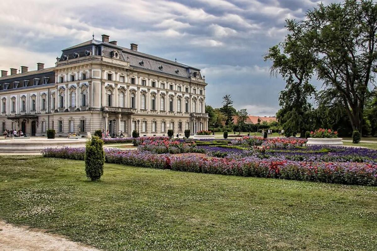 a large building with a flower garden in front of it