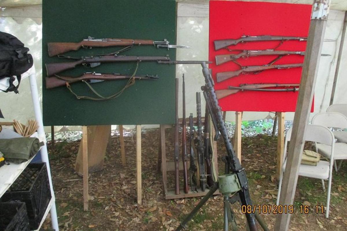 a group of guns on a wall in a room