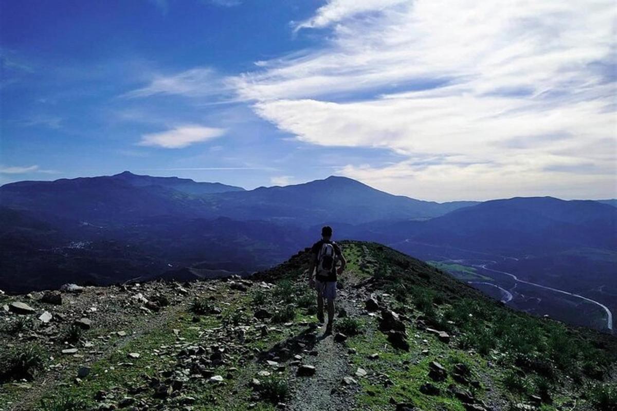 um homem em pé no topo de uma montanha