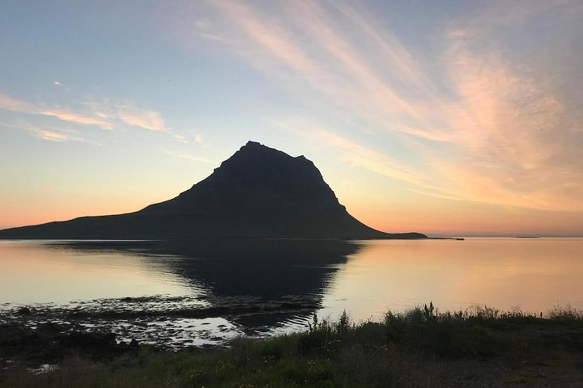 a mountain sitting in the middle of a body of water