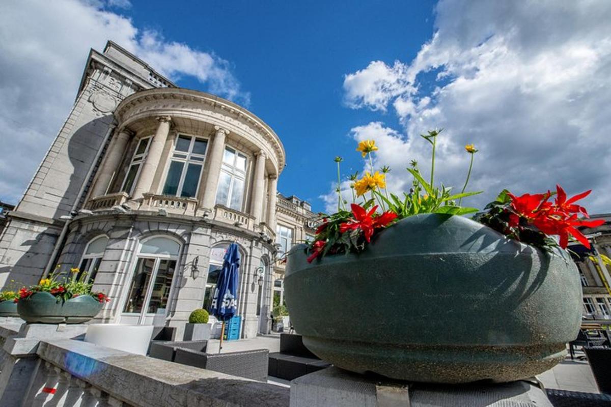 a building with two large vases with flowers in it
