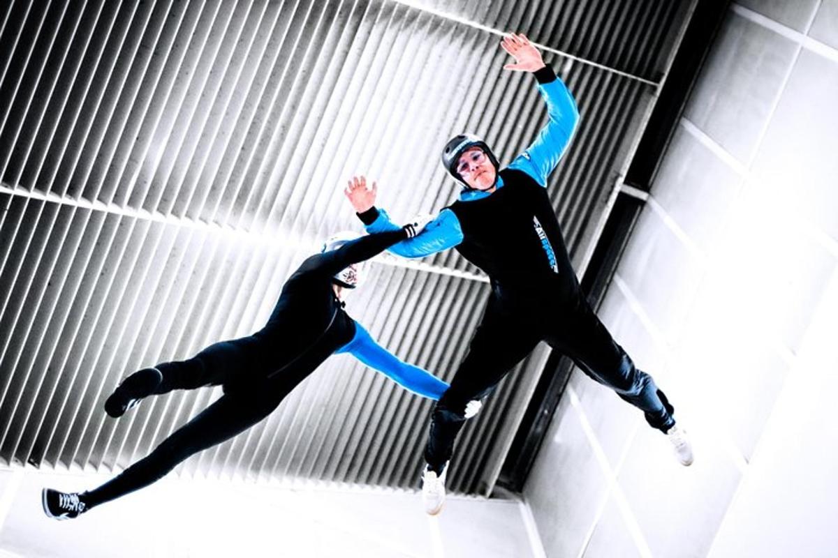 two people jumping in the air on a building