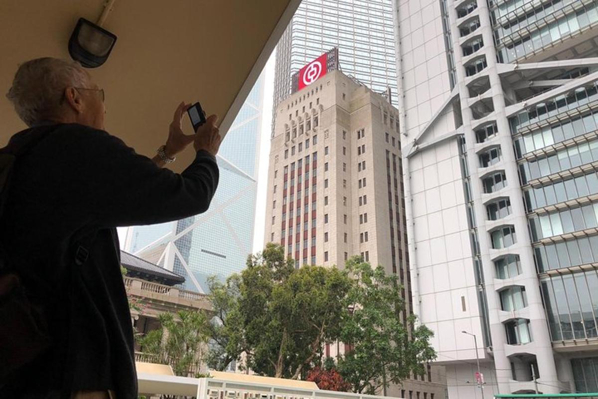 a man taking a picture of a tall building