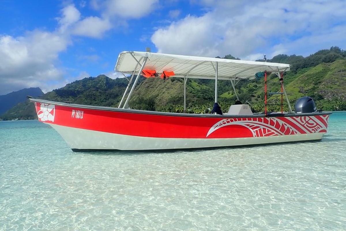 a red and white boat sitting in the water