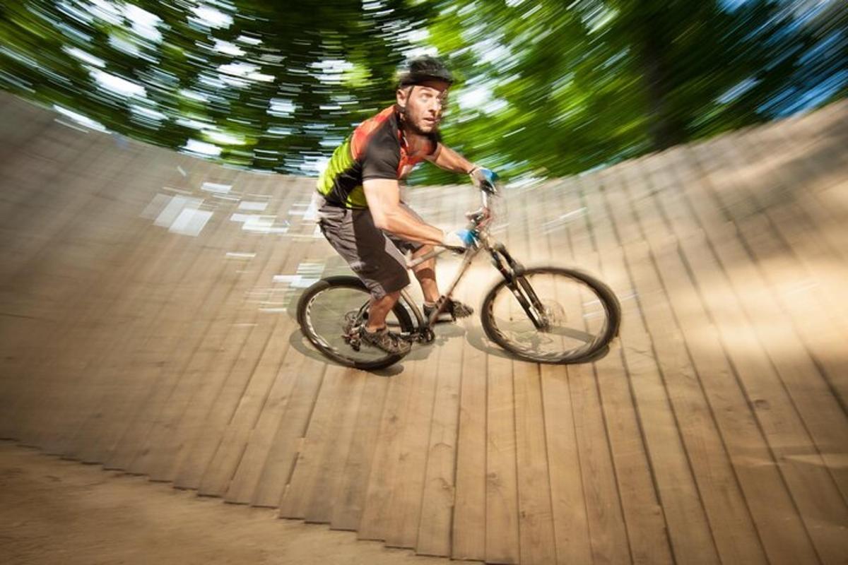 a man riding a bike on a wooden path