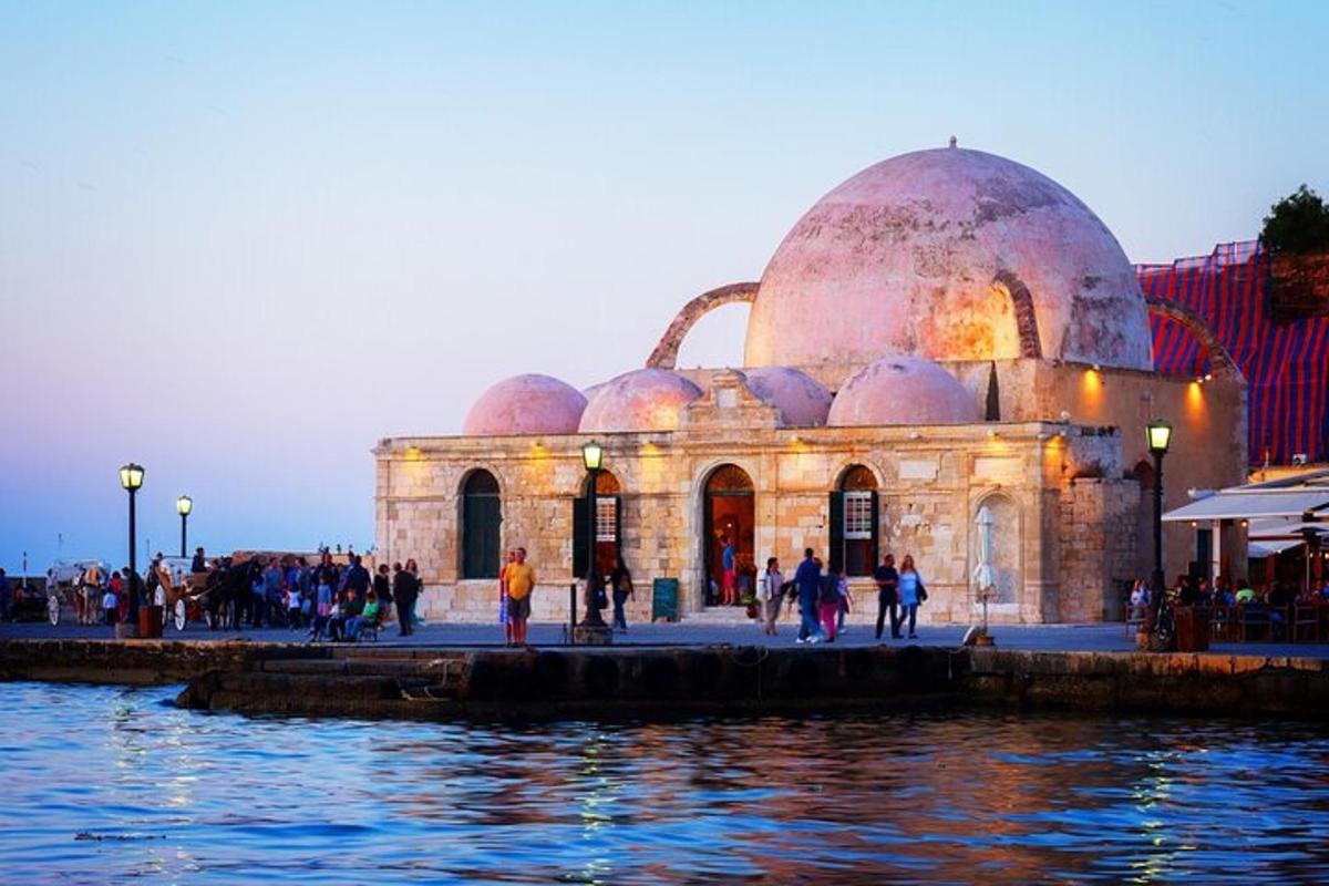 a building with domes next to a body of water