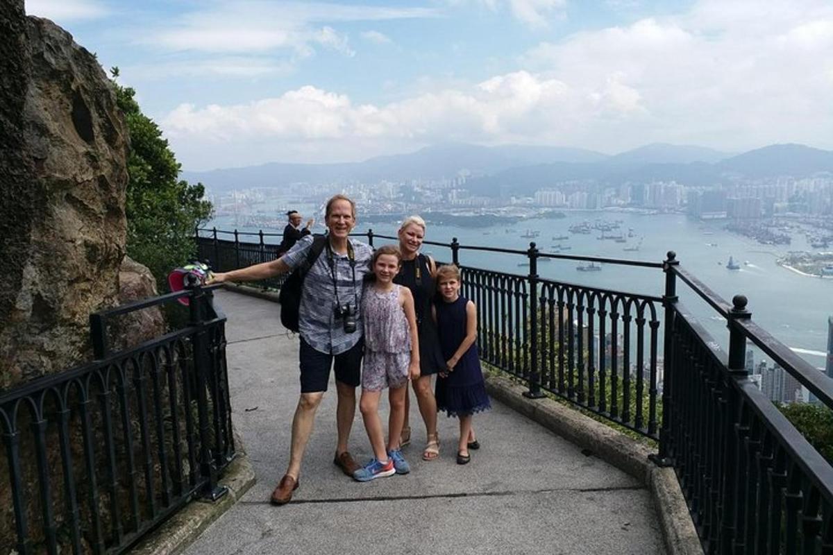 a family posing for a picture on top of a mountain