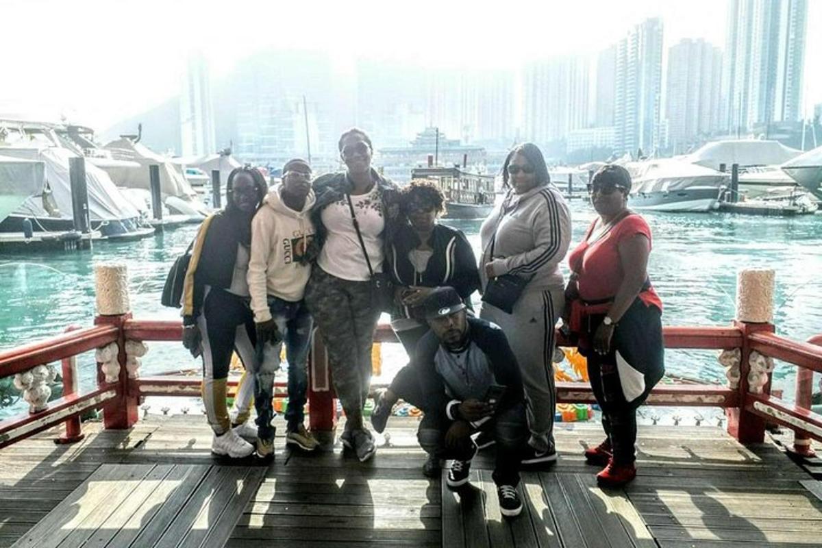a group of people standing on a dock near the water