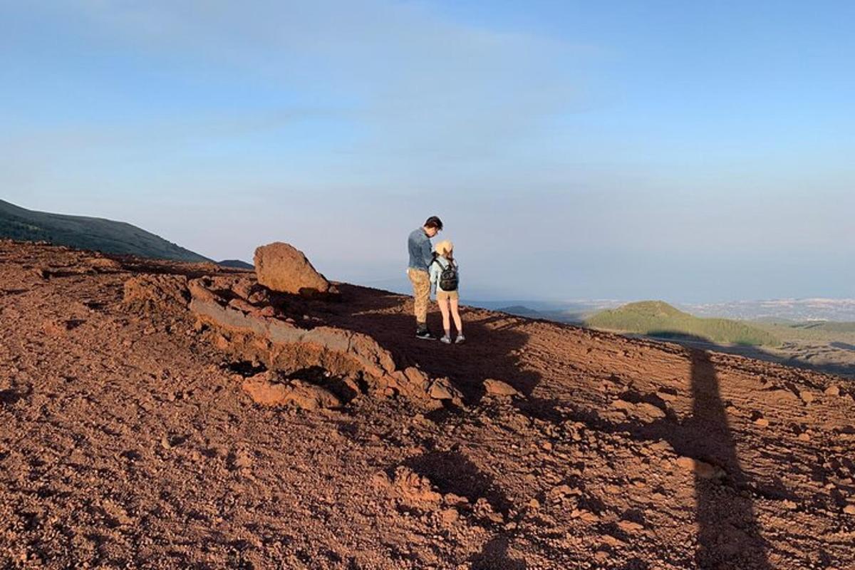 a man and a woman standing on top of a mountain