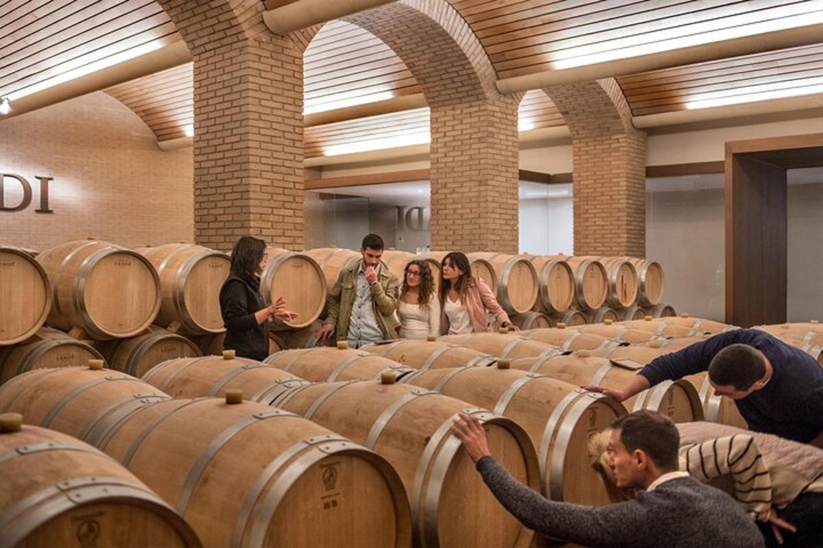 a group of people standing around barrels in a room
