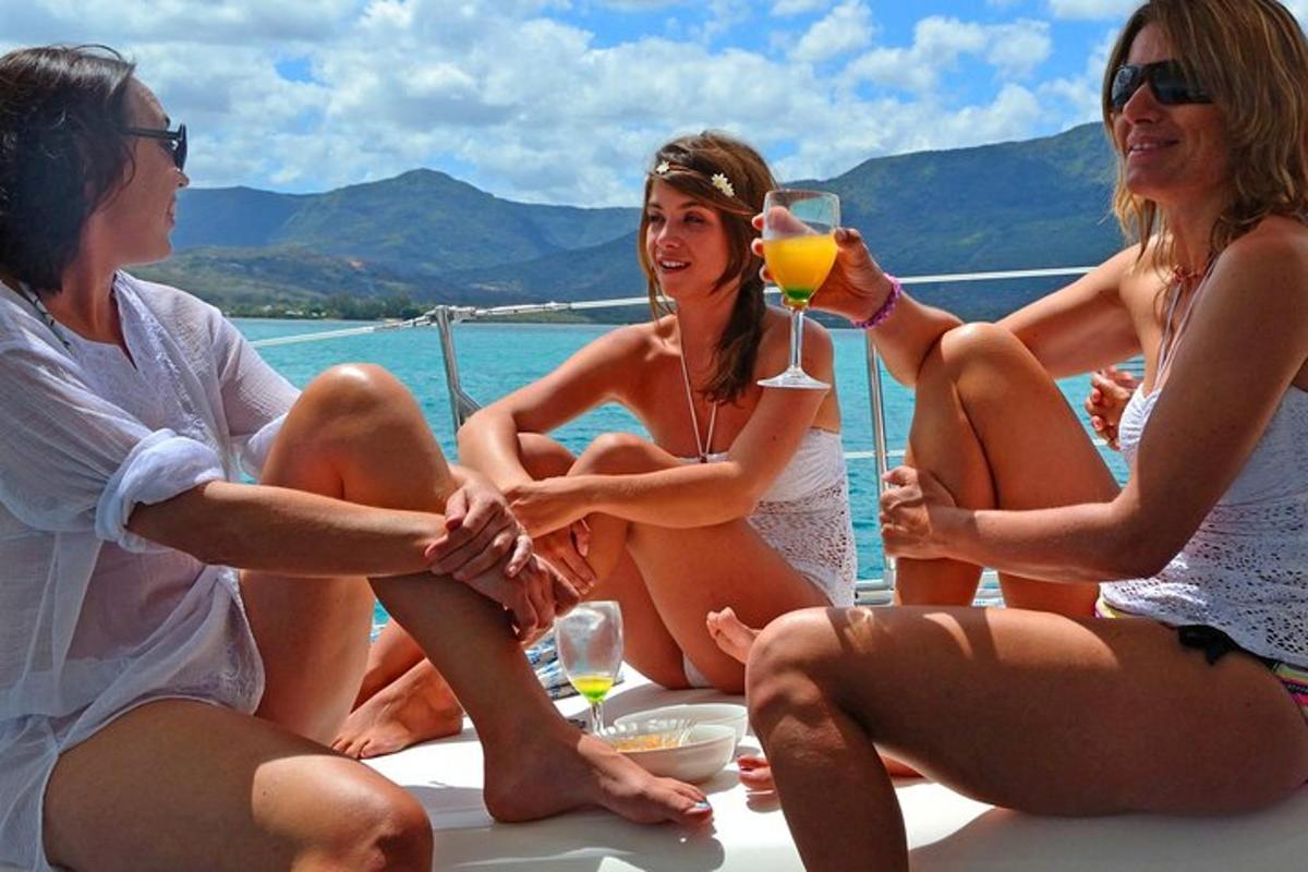 a group of women sitting on a boat drinking wine
