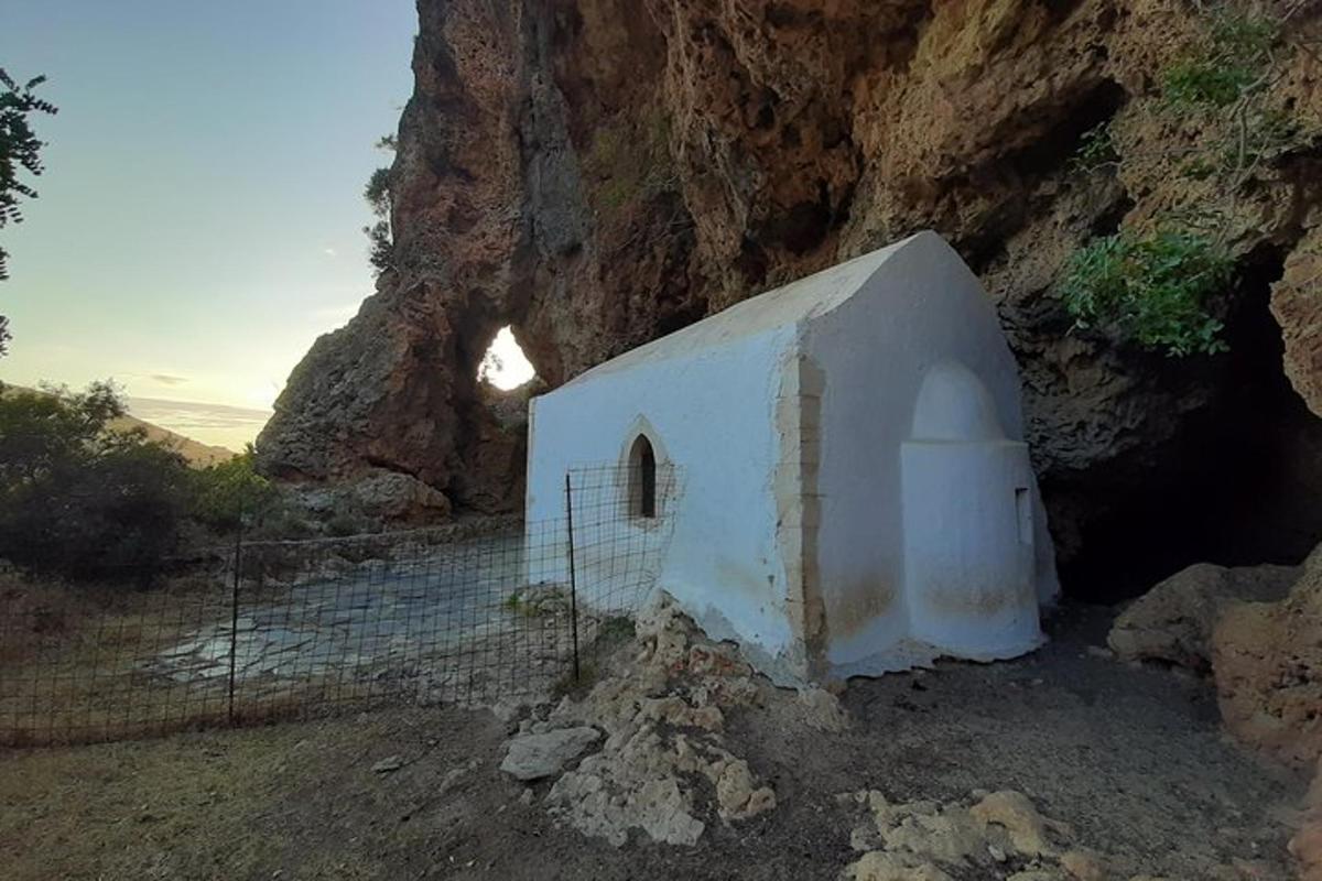 a small building in the side of a mountain