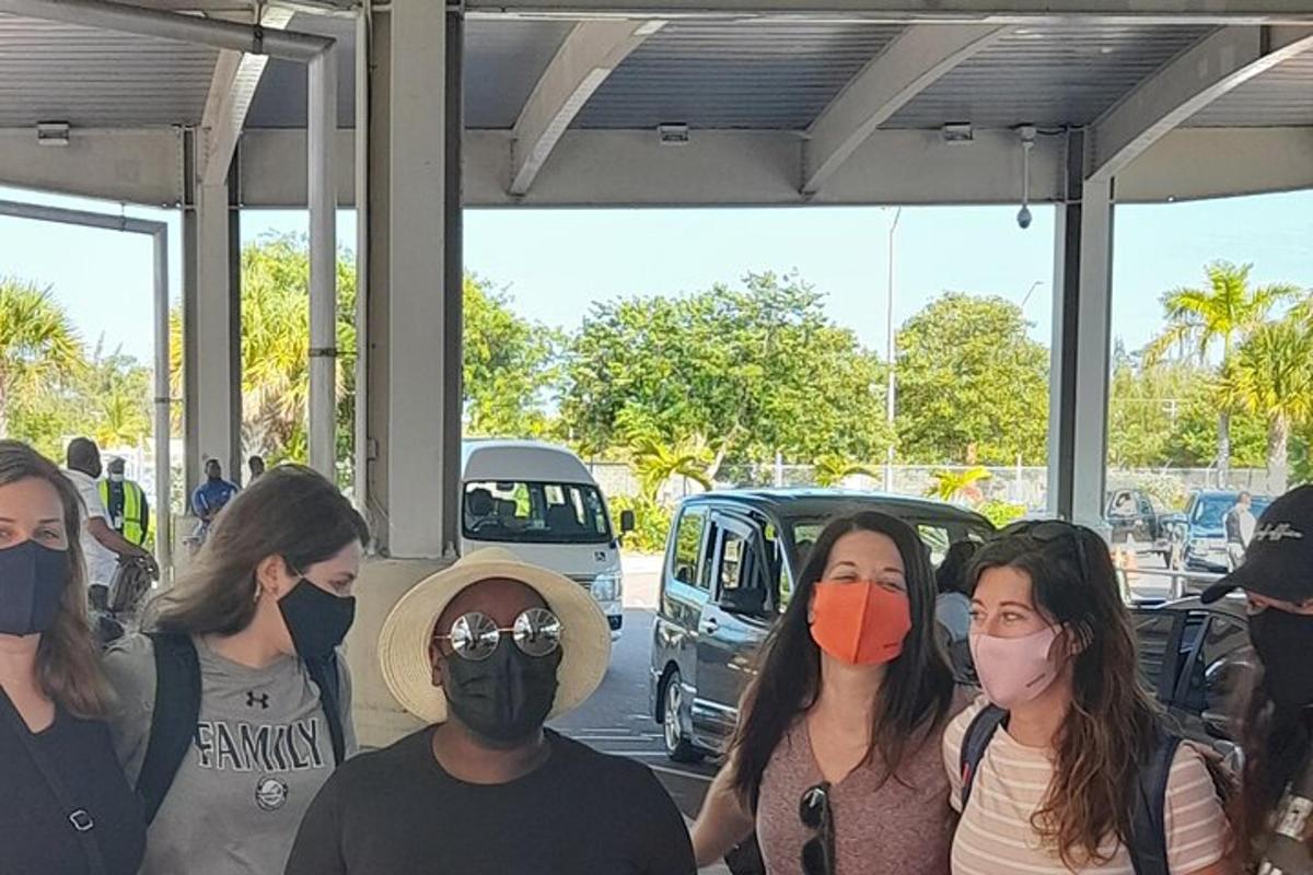a group of people wearing masks in a parking lot