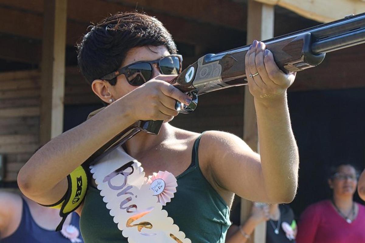 a woman holding a large gun in her hand