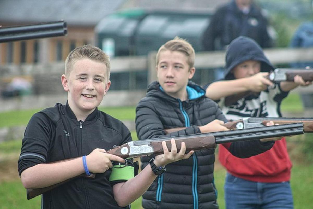 a group of boys holding a toy gun