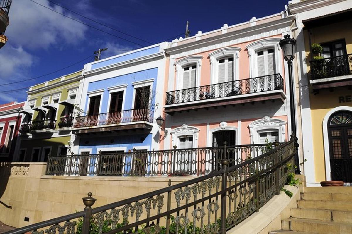 a row of houses with balconies and a fence